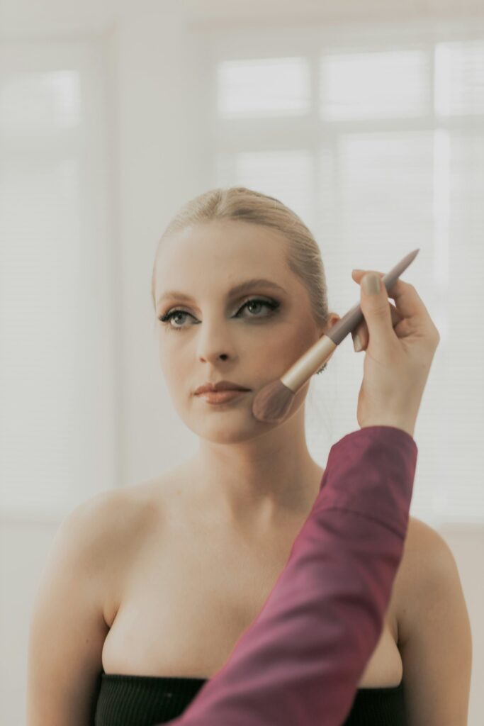 women blending makeup with brush