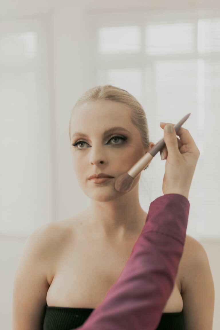 women blending makeup with brush
