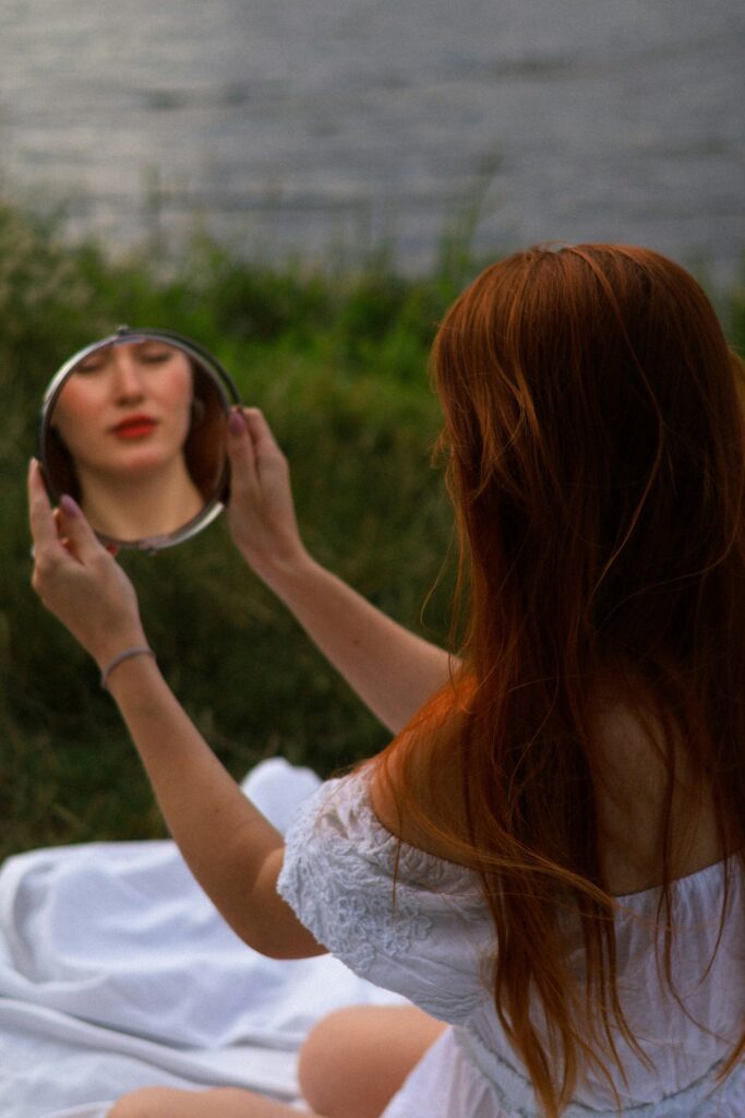 women looking at her face in mirror