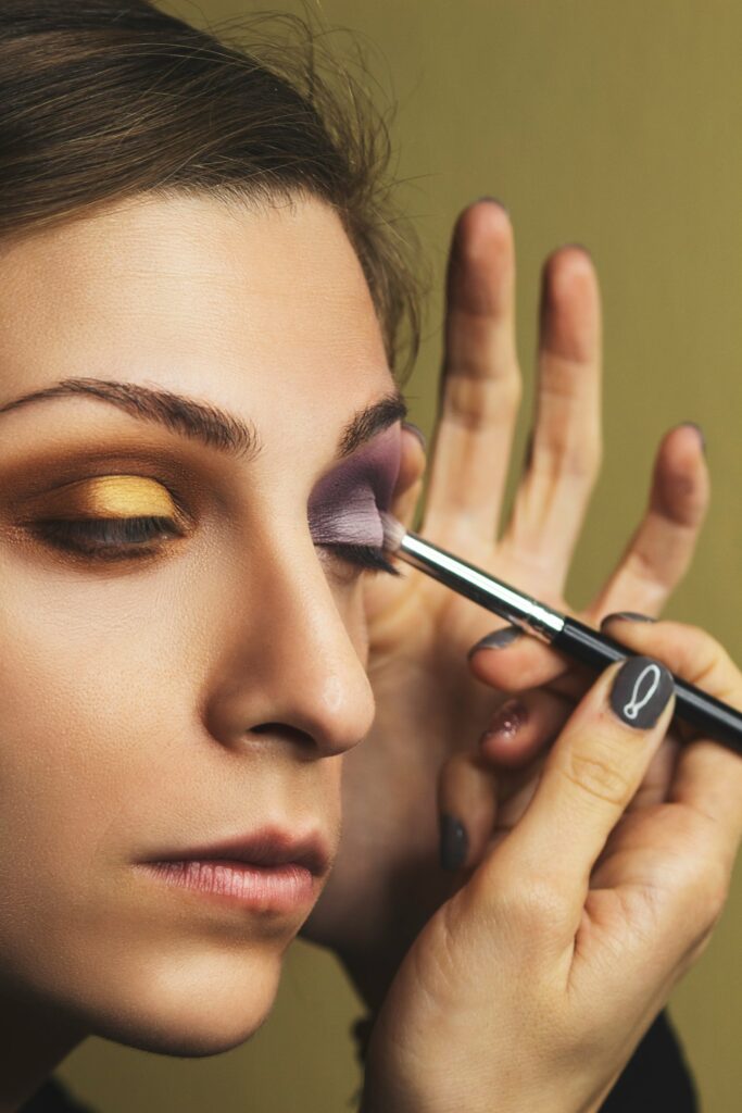 women applying eye makeup