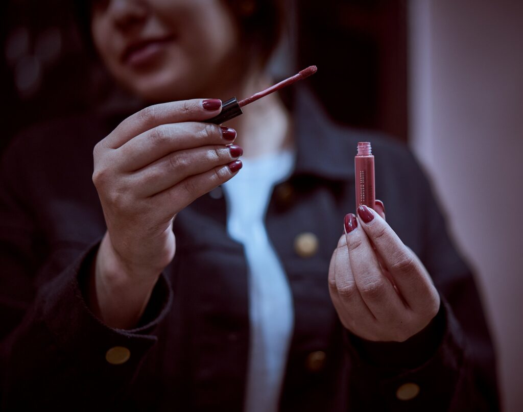 women holding lip gloss