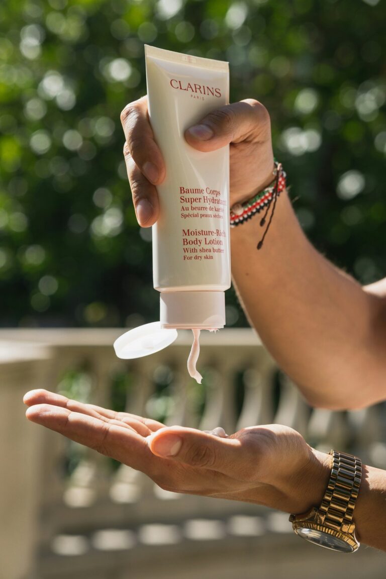 women squeezing moisturizer in her hand