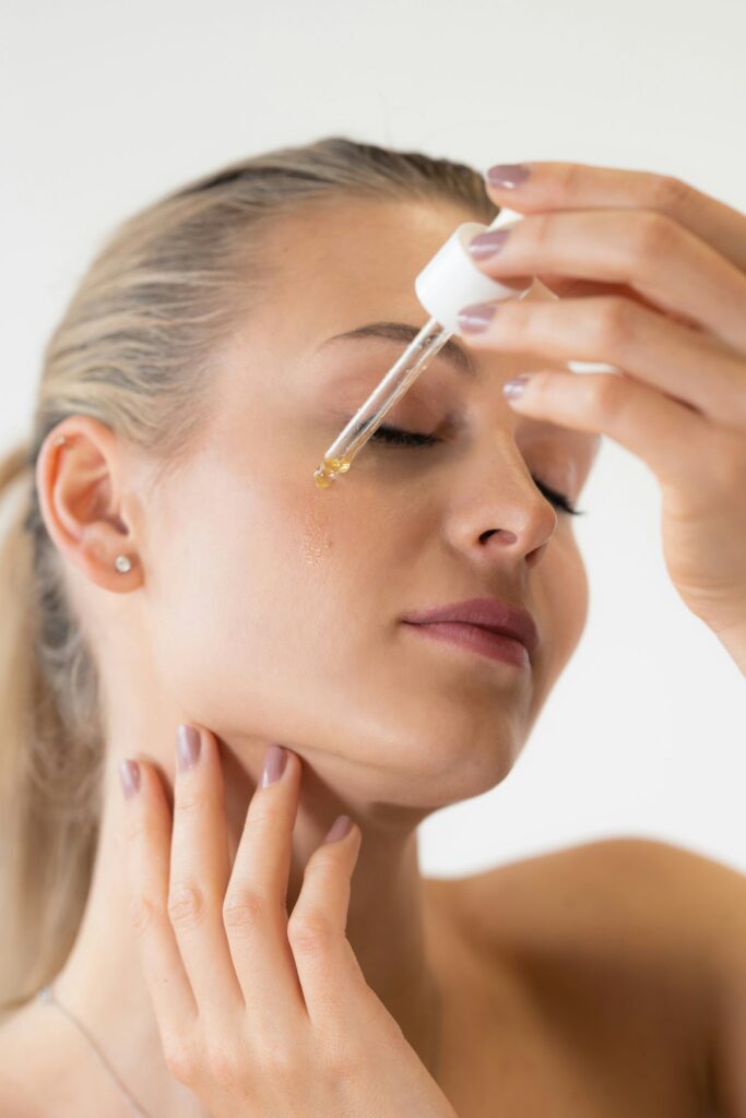 women closeup face applying serum