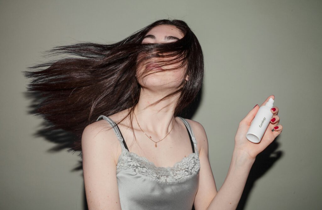 women holding hair product with long flying hairs