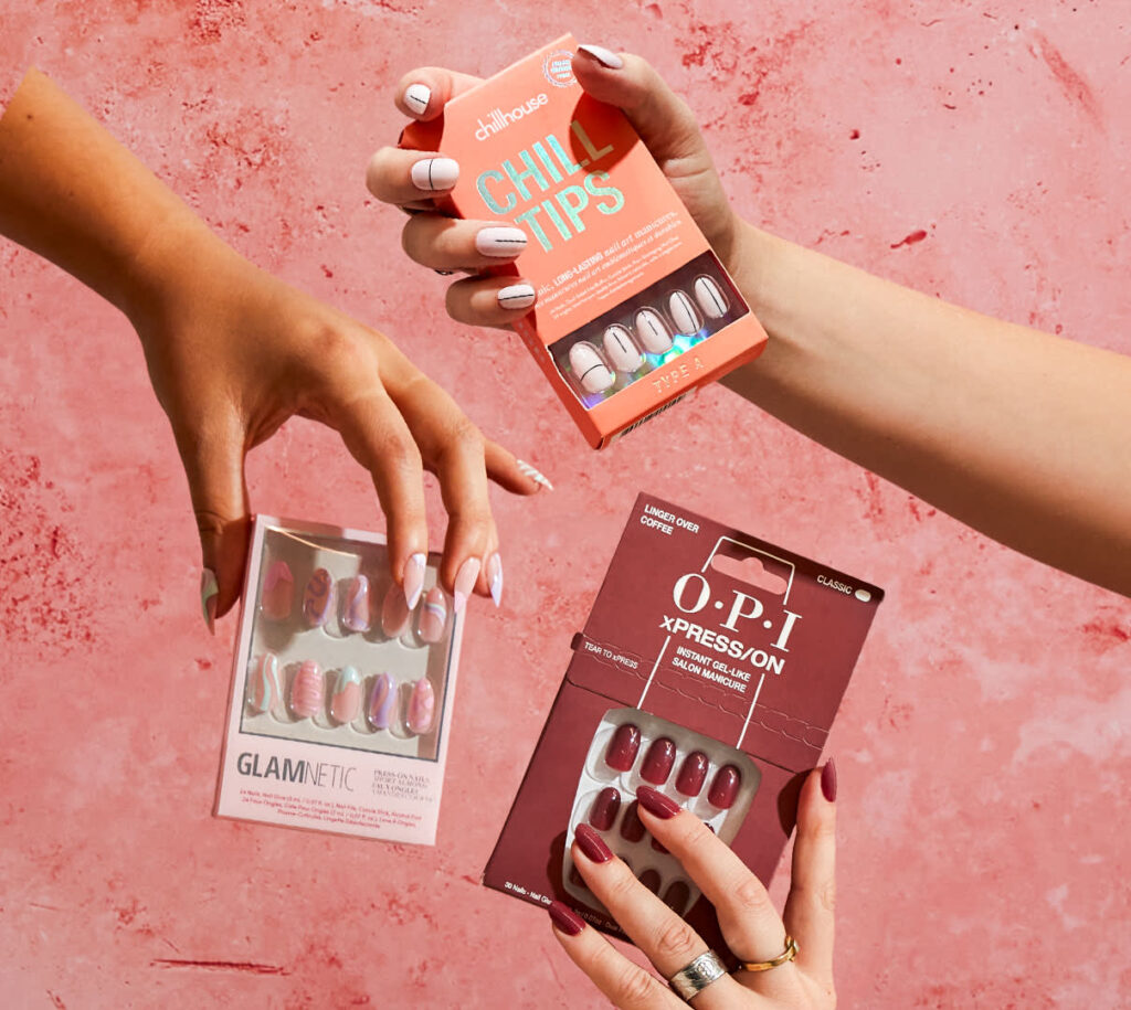 hands holding press on nail packets