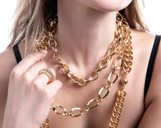 women wearing gold necklace