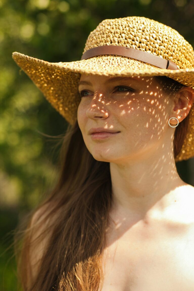 women wearing hat standing in sun