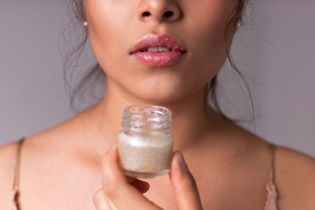women holding lip product