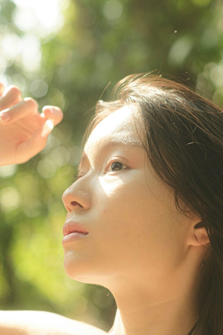 women shading her face with hand from sun