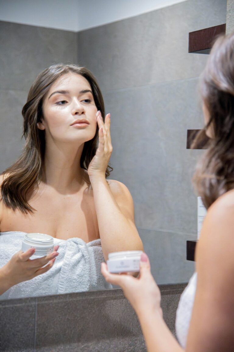 women applying moisturizer