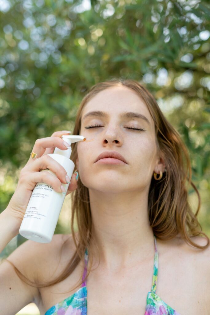 women applying sunscreen on face