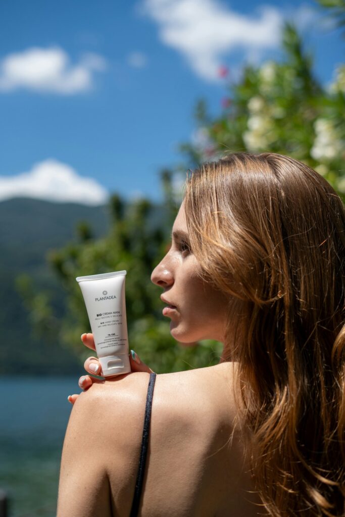 women showing sunscreen on shoulder