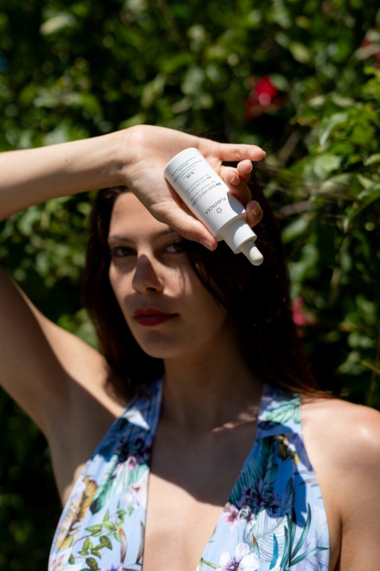 women holding sunscreen bottle