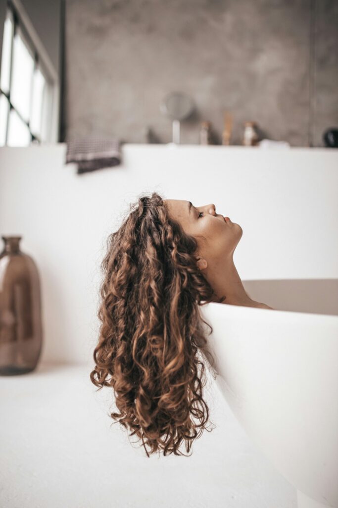 women in a tub with her head resting