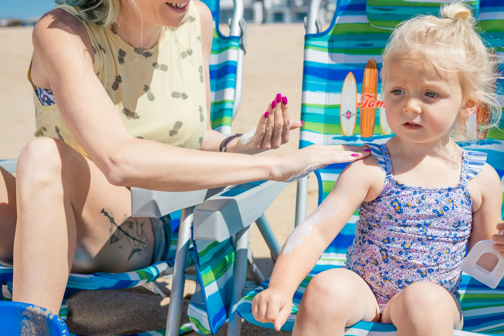 Family applying water-resistant sunscreen by a pool for safe summer fun